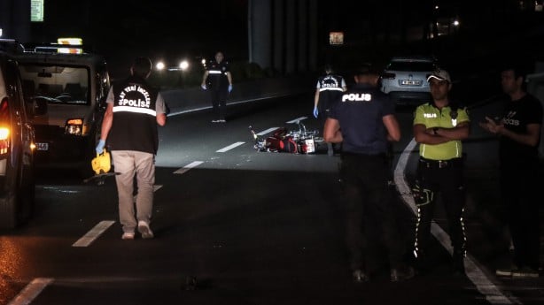 Devrilen motosikletten yola savrulan iki kişinin üzerinden araba geçti