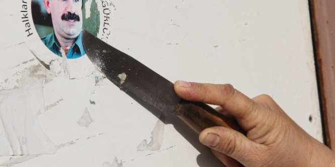 Polisi gören kadın Öcalan çıkarmasını bıçakla kazıdı