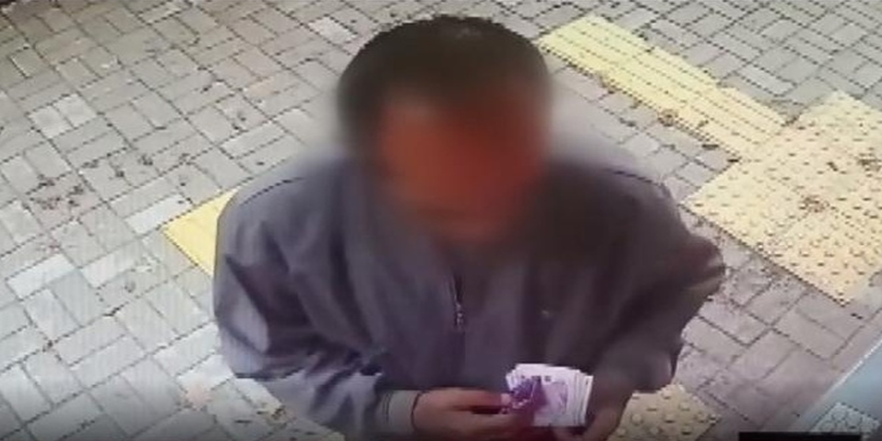 ATM'de unutulan parayı alan şüpheli...