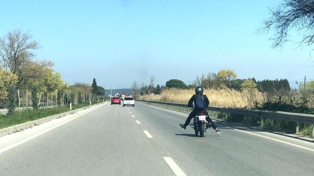 Müzik dinleyen motosikletçiden trafikte tehlikeli hareketler 