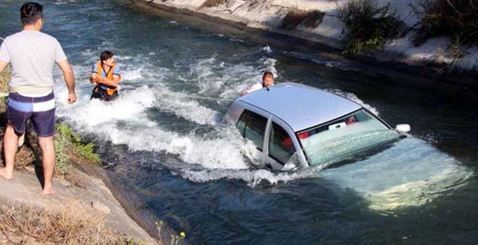 Otomobili ile su kanalına düşen eşini kurtarmak için ölüme meydan okudu