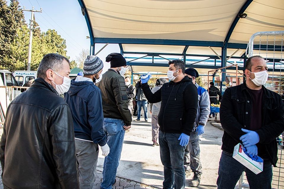 Pazara gelenlerin ateşi ölçülüyor, eldiven ve maske dağıtılıyor 