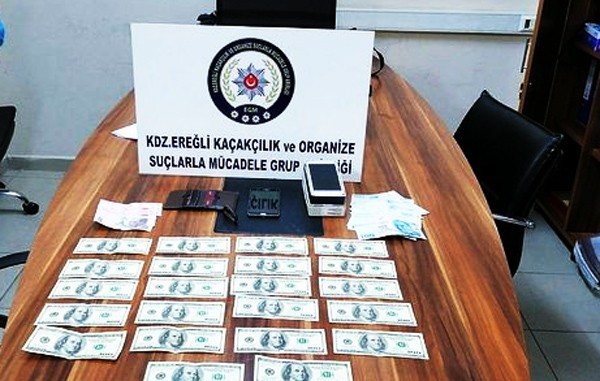 Piyasaya sahte dolar süren zanlılara gözaltı 