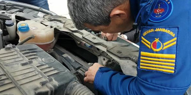 Polis aracının motoruna sıkışan kediyi jandarma kurtardı