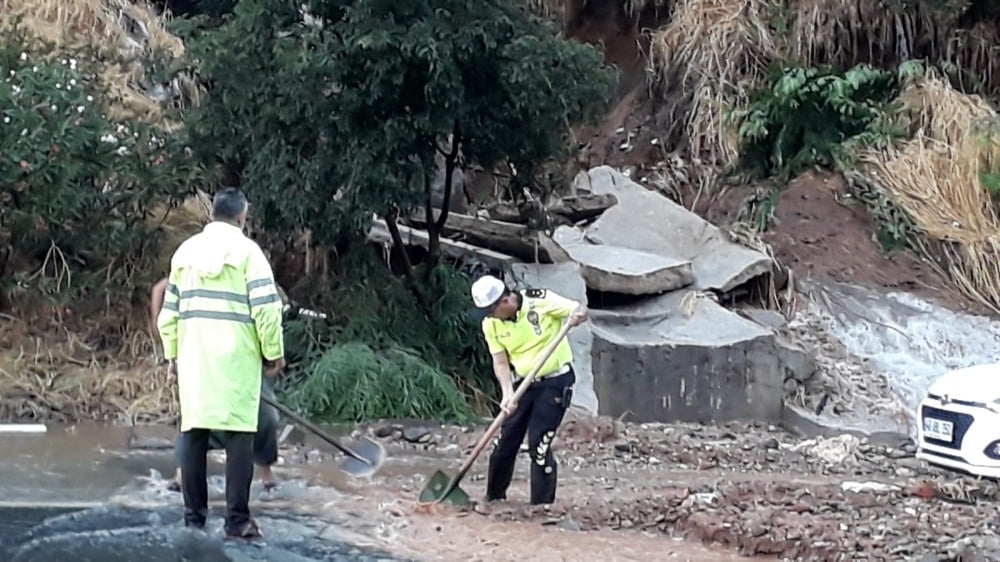 Polis elinde kürekle otoyoldaki toprağı temizledi 