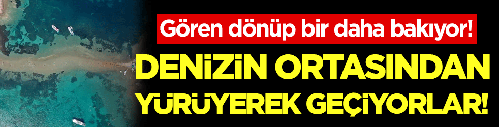 Gören dönüp bir daha bakıyor! Denizin ortasından yürüyerek geçiyorlar!