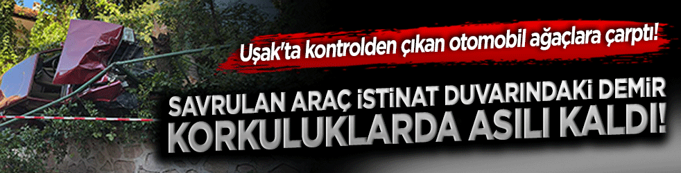 Uşak'ta kontrolden çıkan otomobil ağaçlara çarptı! Savrulan araç istinat duvarındaki demir korkuluklarda asılı kaldı!